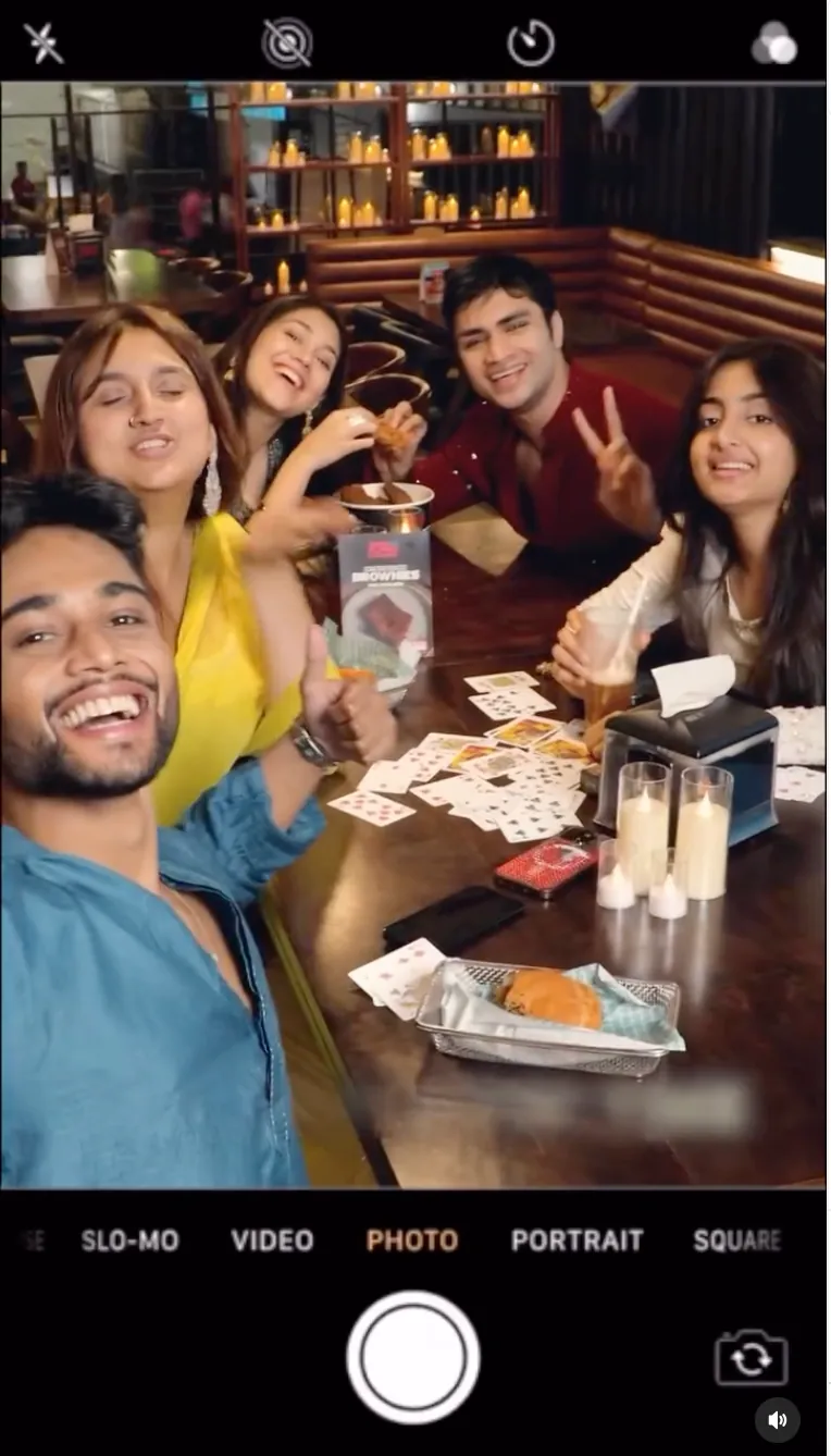 Friends taking a selfie over a table of burgers