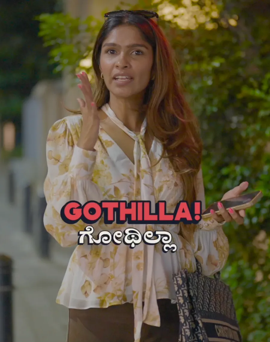 A woman reacting to camera with the caption Gothilla