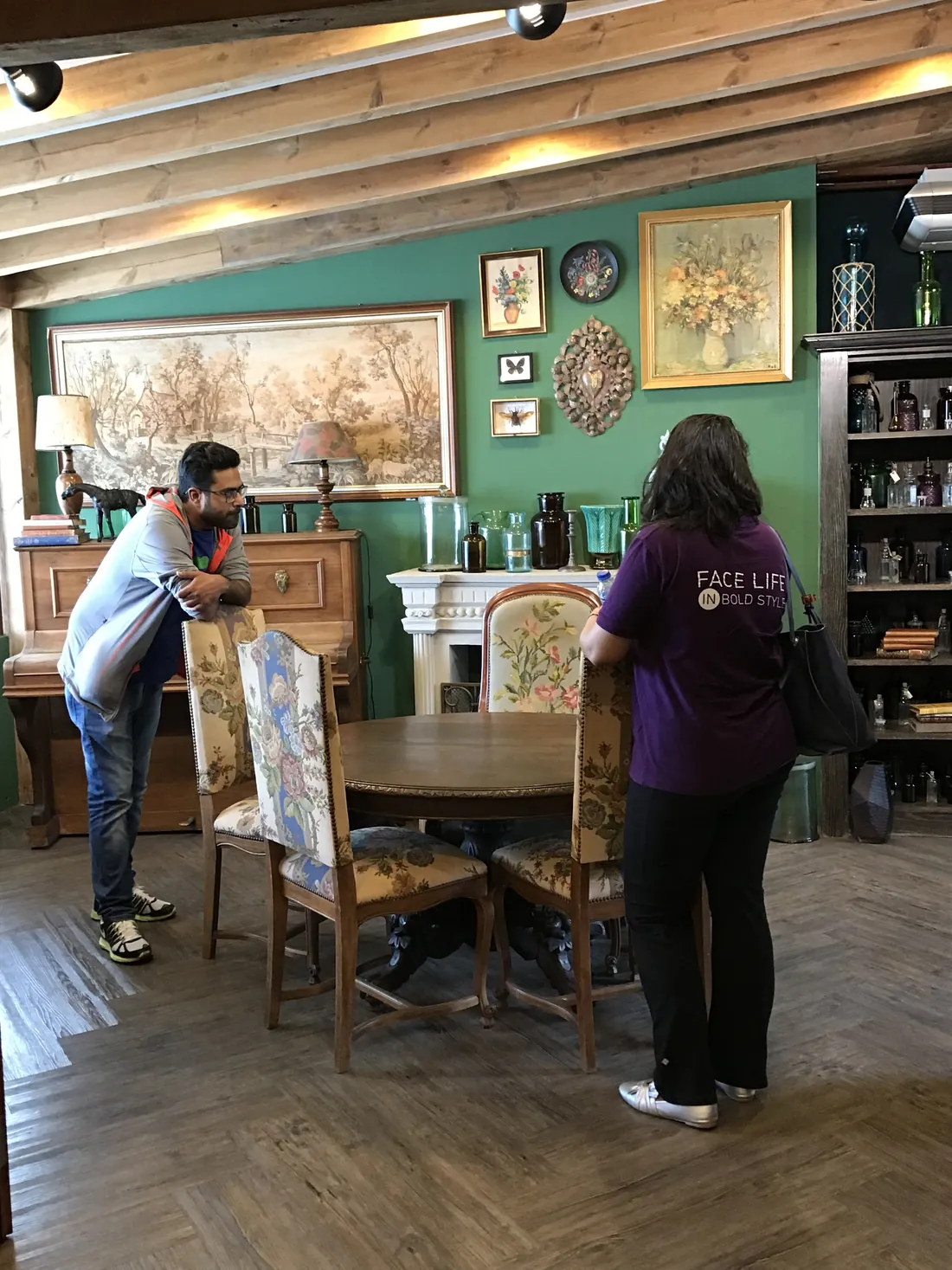 Dinesh setting up a shot in a green-walled café in Bangkok