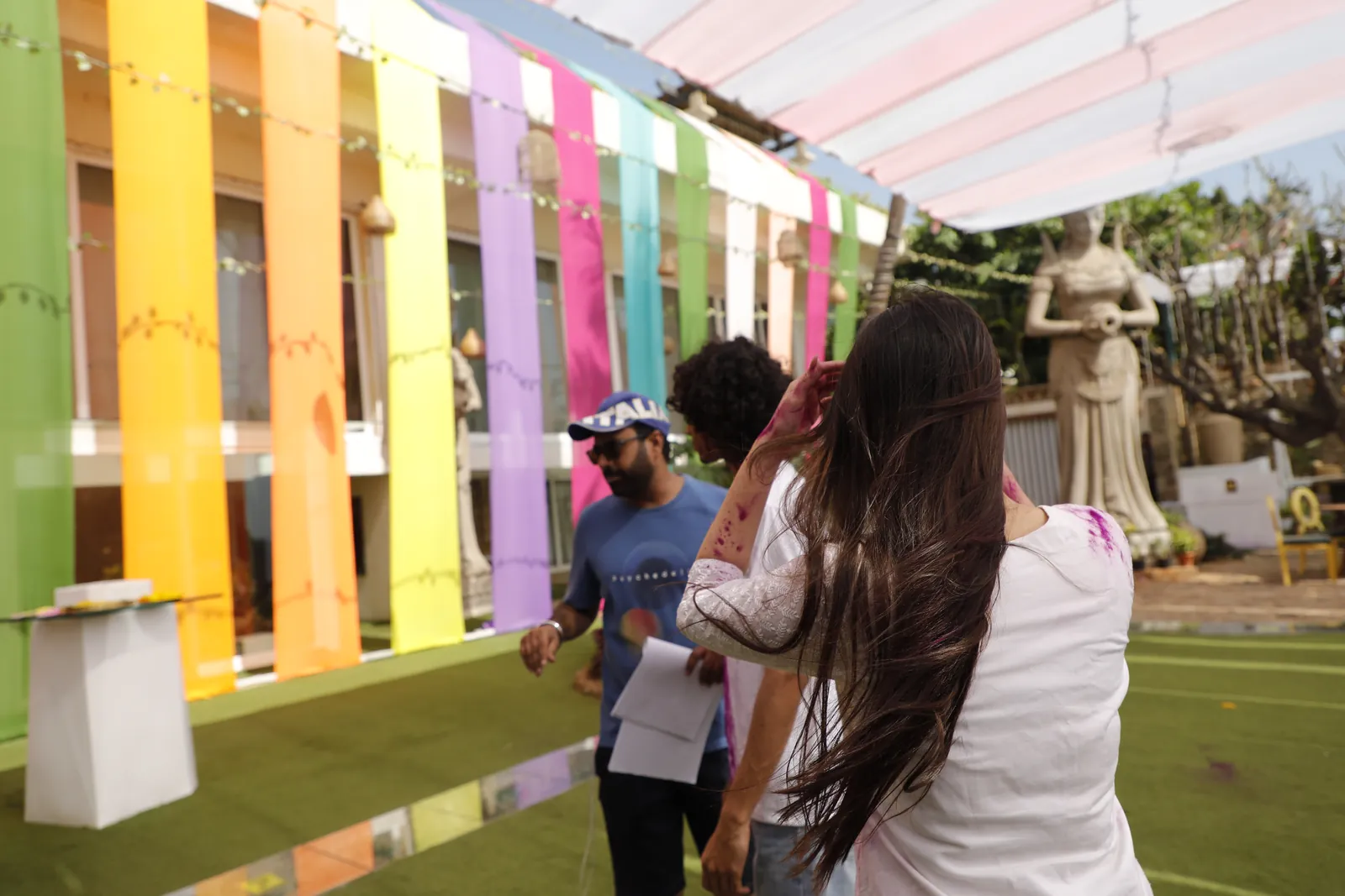 Dinesh directing on a Holi set strung with coloured fabric